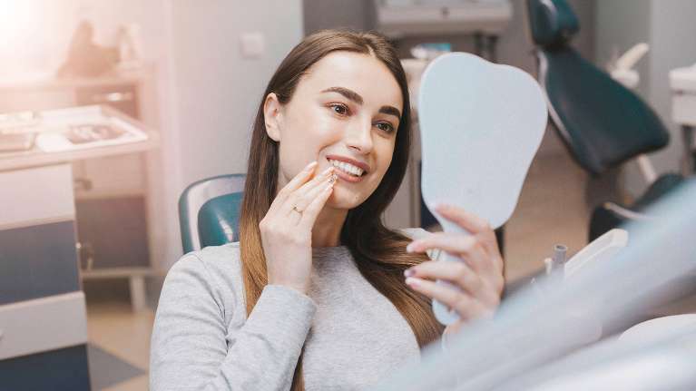 woman admiring her cosmetic dental work in bondi junction